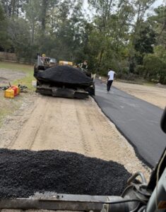Asphalt paver and fresh asphalt on new paving job